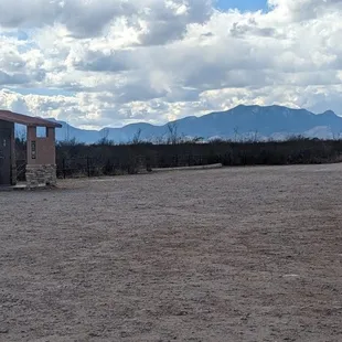 Pit toilet in large parking area