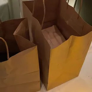 two brown paper bags on a table