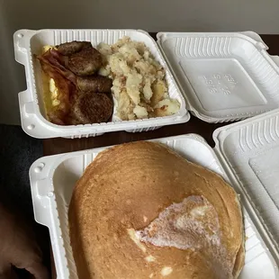 Pancakes, eggs, sausage, bacon, and home fries