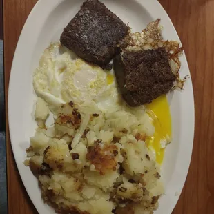 Scrapple, eggs and home fries with onions.