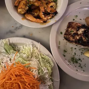 a variety of plates of food on a table