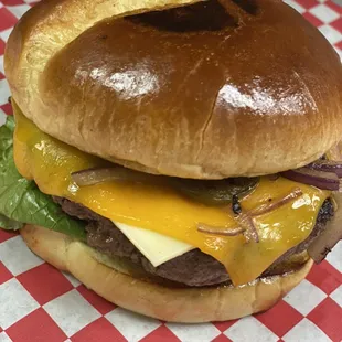 angus fresh never frozen cheeseburger topped with cheddar cheese and musalettis signature sauce!!
