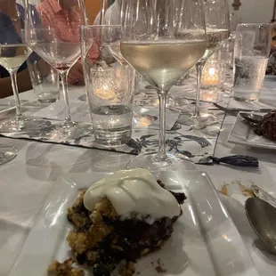 a plate of dessert and wine glasses