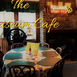 a table and chairs in front of a fireplace