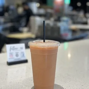 a cup of iced coffee on a counter