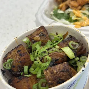 a bowl of tofu and a plate of fries