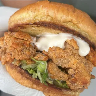 A Locally Sourced Creation- Izzit Chik&apos;n - Fried Oyster Mushroom, Garlic aioli, House made pickles, and Romaine lettuce.