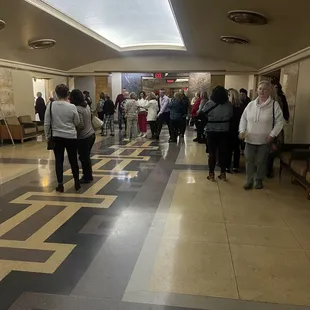 people walking through a music hall