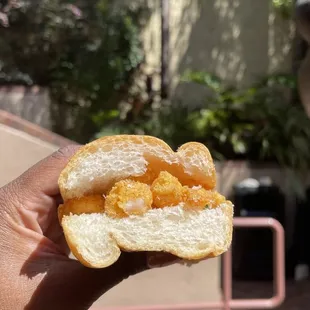 a hand holding a sandwich