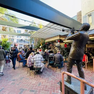 a statue of a man playing a trumpet