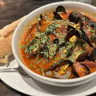 a bowl of mussel and cheese soup