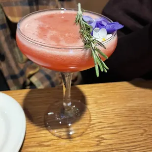 Made with passion fruit, with a garnish of edible flowers, rosemary &amp; a smoky essence. You would just have to try it to believe it!