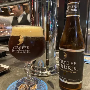 a glass of craft beer next to a bottle of craft beer