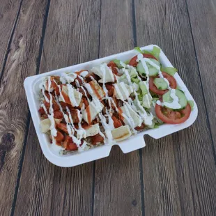 a salad in a styrofoam container