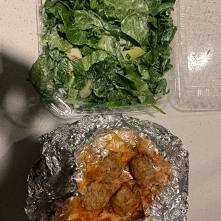 a plate of meat and a salad