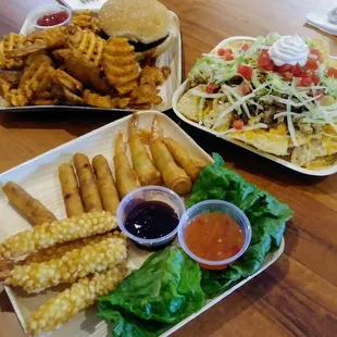 Sampler: tempura shrimp, cuban cigar wraps and asian shrimp wraps w/ sauces. Brisket sandwich with waffle fries. Grilled chicken nachos. YUM