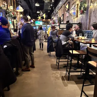 people sitting at tables in a restaurant