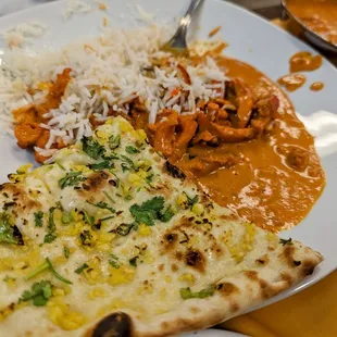 a plate of food with rice and chicken