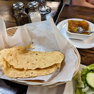 a basket of tortillas and a salad