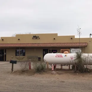 a gas tank in front of a gas station