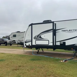 Paved pad, grass strip with picnic table, full hook ups.