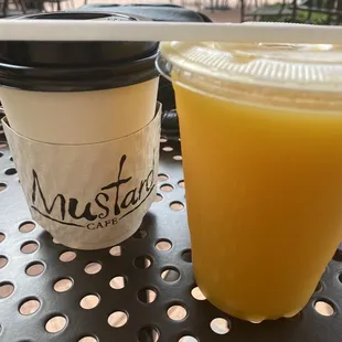 a plastic cup of orange juice and a plastic cup of orange juice