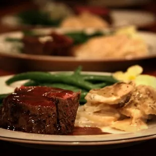Filet mignon with a port reduction sauce, served with thyme scalloped potatoes and lemon garlic green beans.