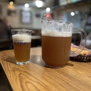 a pitcher and a glass of beer