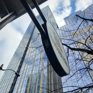 a street sign in front of a tall building