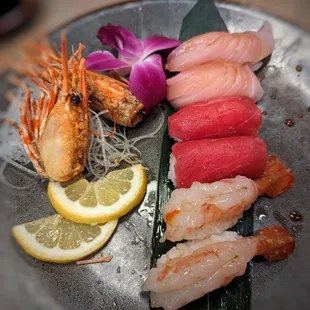 a plate of sushi and shrimp