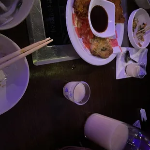 a plate of food with chopsticks and sauce