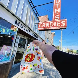 a hand holding a bag of candy