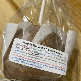 a chocolate donut wrapped in plastic