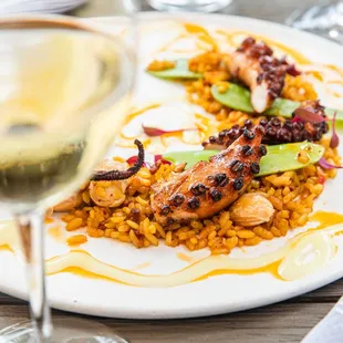 Grilled Spanish Octopus

Bomba rice, saffron, house socarrat chips, pimentón oil,
garrofón beans, sugar snap peas, pepper vinaigrette