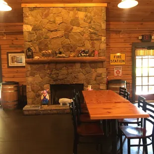 a table and chairs in front of a fireplace