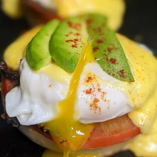eggs benedict with avocado and tomato