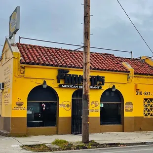 a yellow building on a street corner