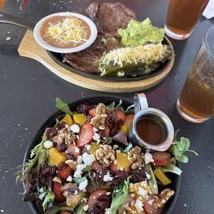 a plate of salad and a glass of beer