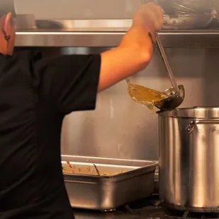 a man cooking in a commercial kitchen