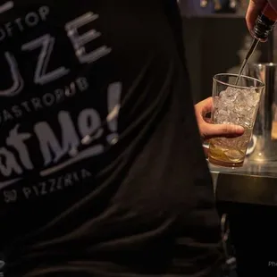 a bartender pouring a drink