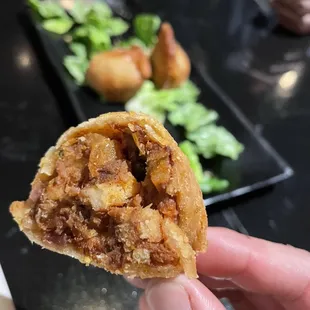 a hand holding a piece of food