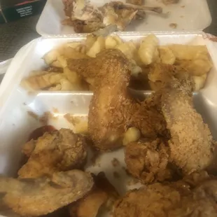 fried chicken and potatoes in a styrofoam container