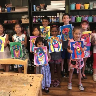 Monday 6-8 year old art class displaying their Dog pictures!