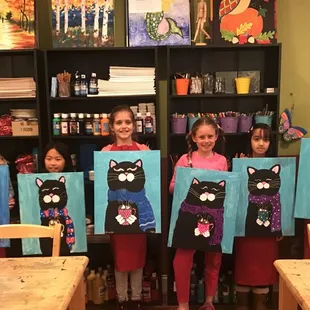 Kids celebrating a birthday at the Carmel Myart studio by painting Cats with acrylic paint!