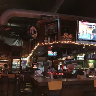 a view of the bar and televisions