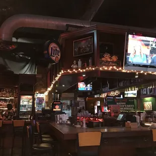 a view of the bar and televisions