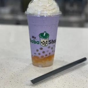 Taro ice blend with whipped cream, mango popping boba, and lychee jelly