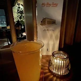 a glass of orange juice on a table
