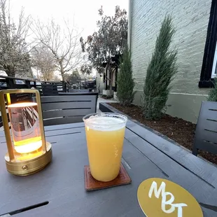a glass of orange juice on a table