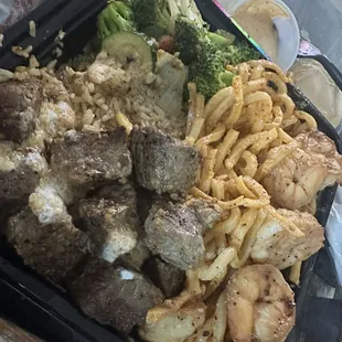 Filet minon, shrimp, veggies and noodles.